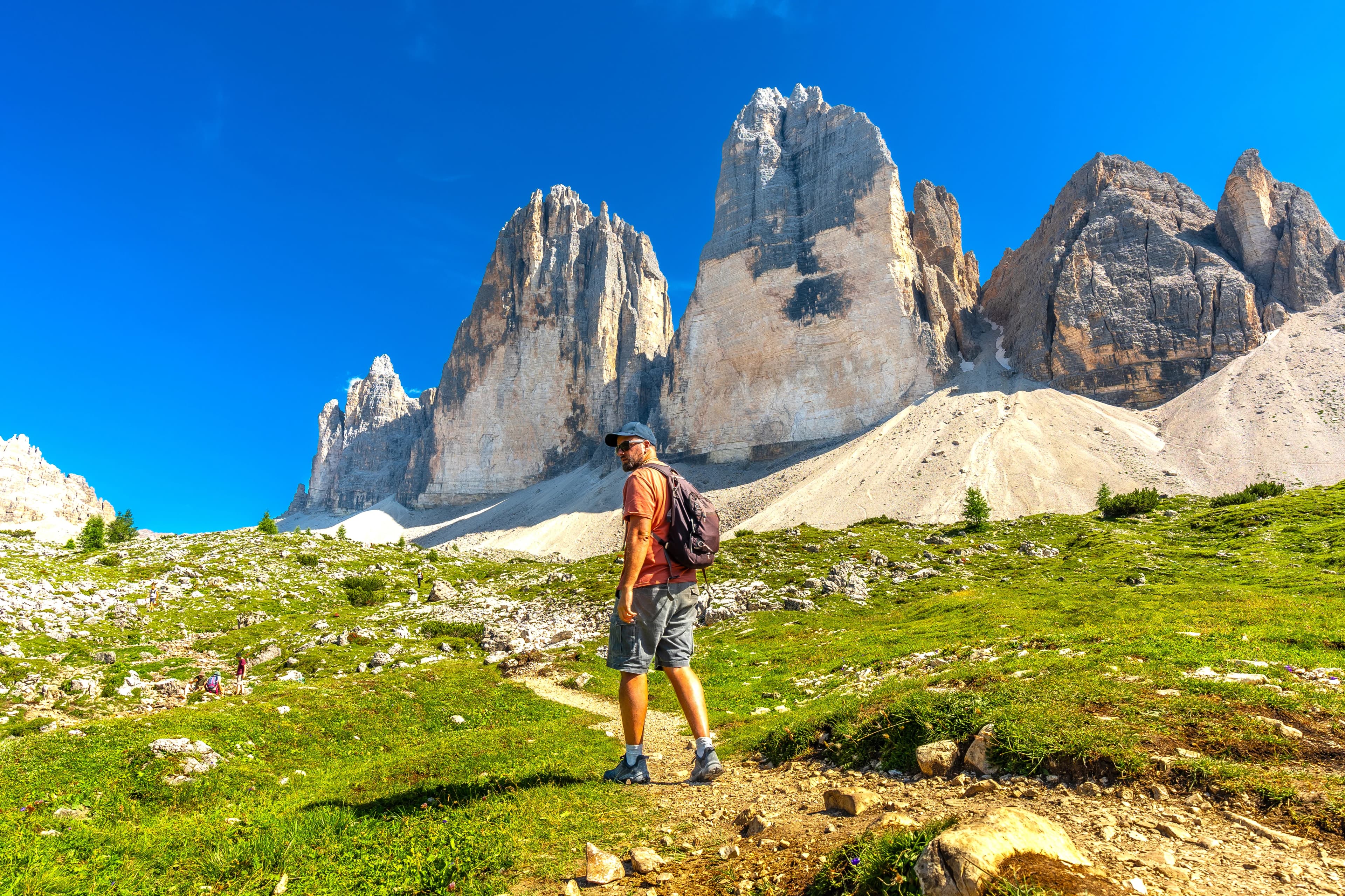Tourist hiking on the tre cime di lavaredo trail in the italian dolomites