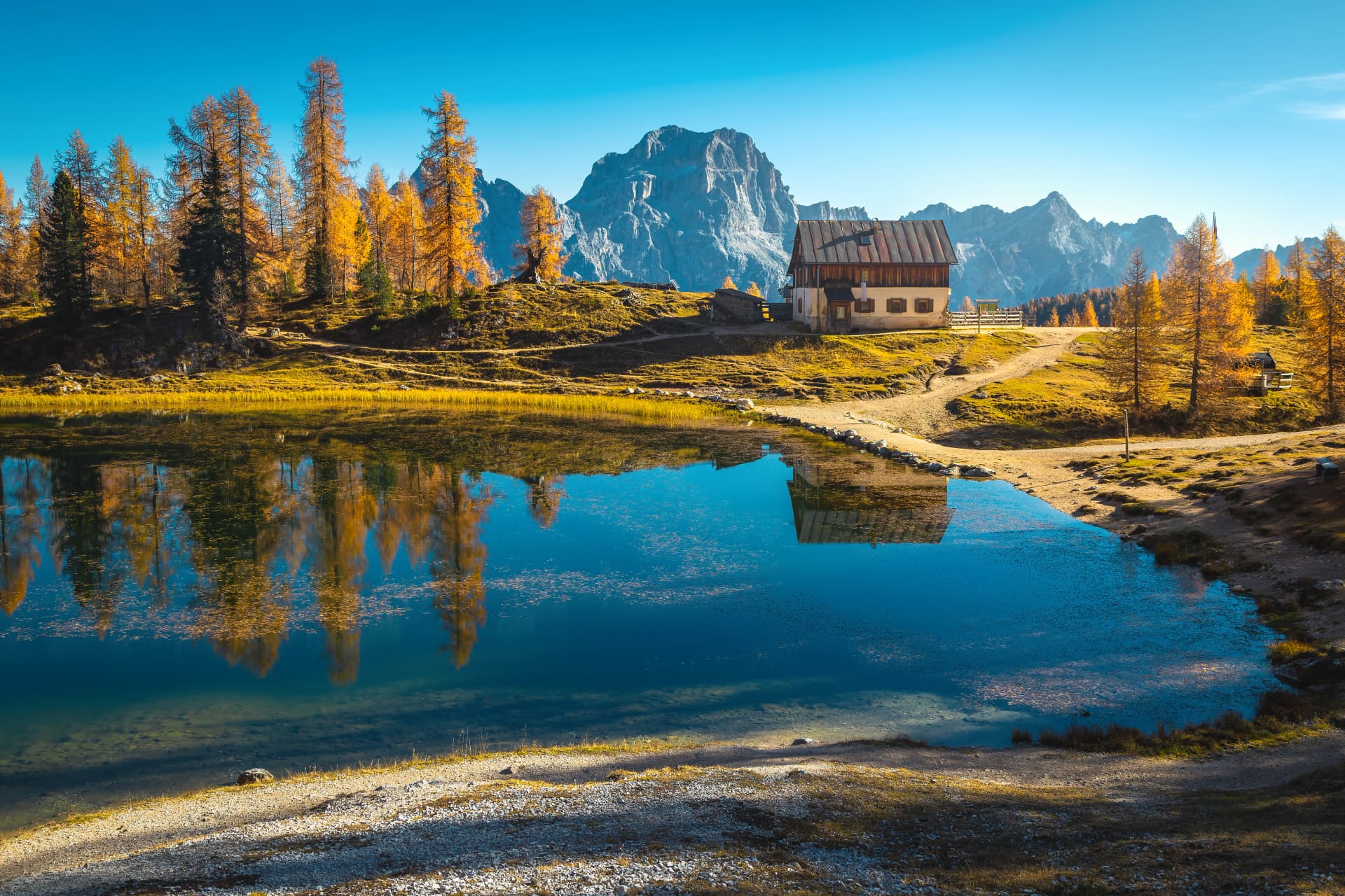 Cute mountain shelter on the lake shore, lake Federa, Dolomites