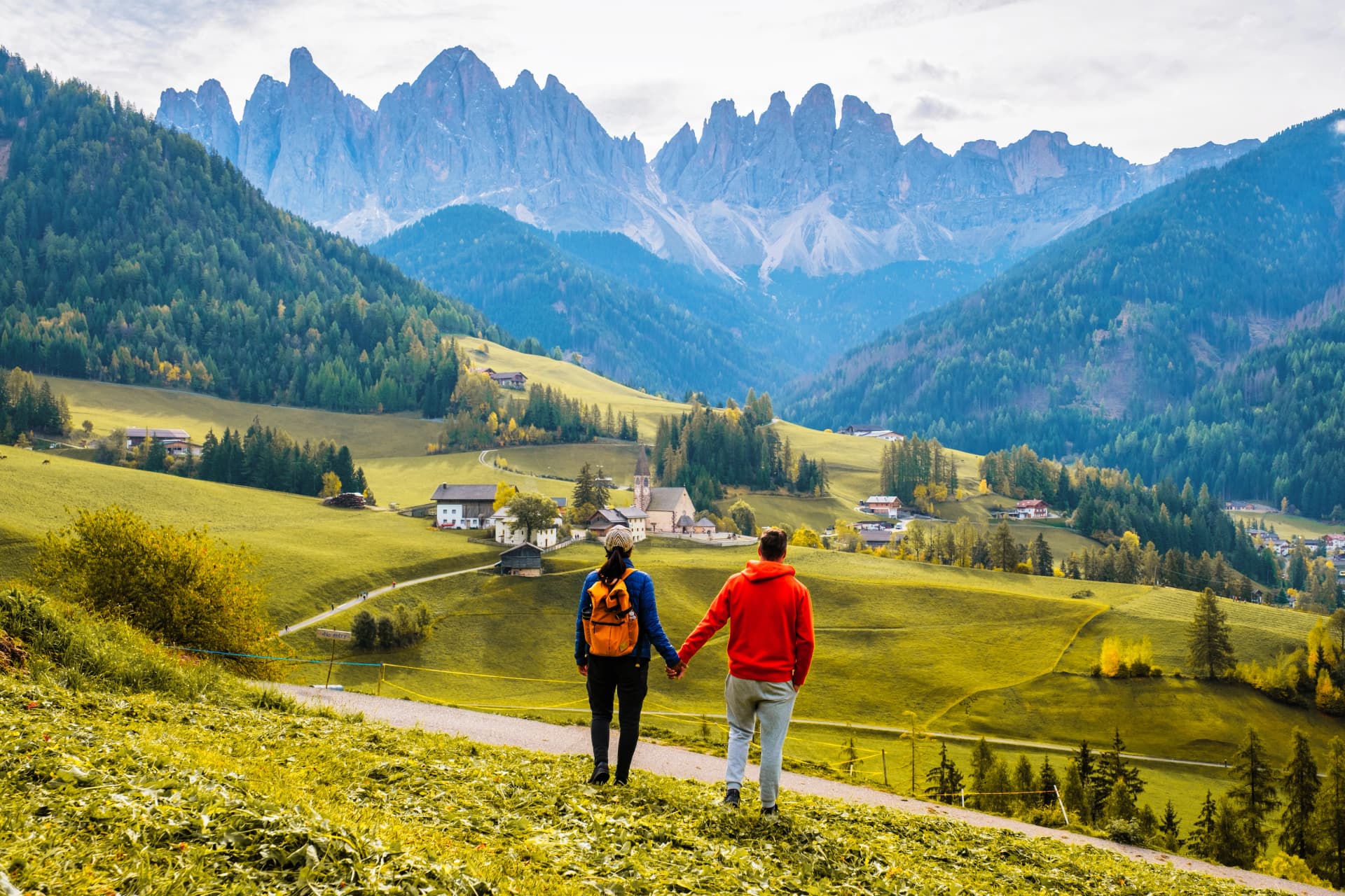 Couple explores the beautiful landscapes of the Dolomites in Italy during a tranquil afternoon