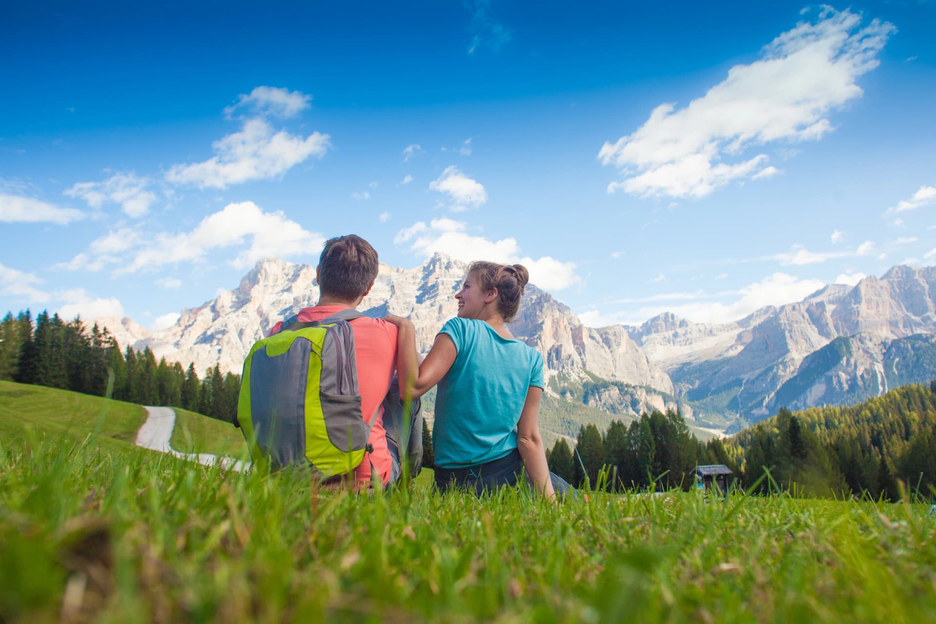 Travelers hiking in breathtaking landscape of Dolomites Mounatins in summer in ALta Badia, Italy.