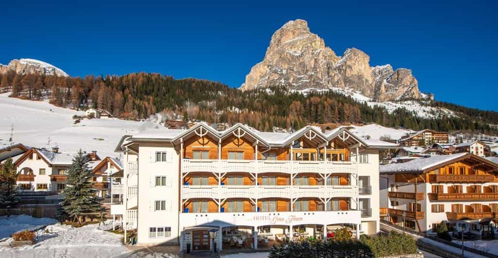 Hotel Gran Fanes building in winter alpine village with snow and mountain peaks