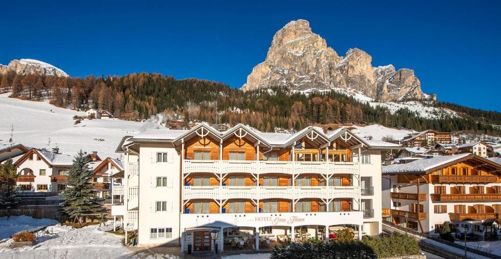 Hotel Gran Fanes building in winter alpine village with snow and mountain peaks